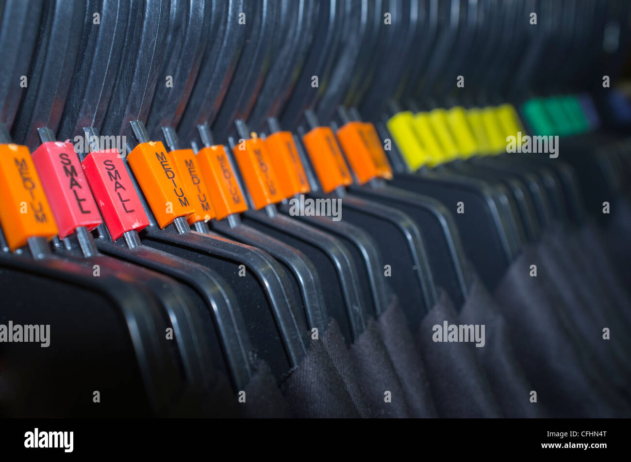 Hangers sorted by size in a clothing shopping center Stock Photo