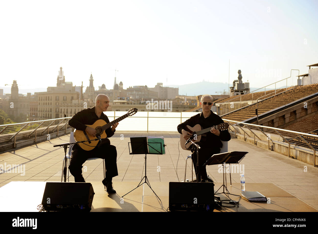 Two Spanish guitarists playing on the roof of the Museum of Catalan History, Barcelona, Spain Stock Photo