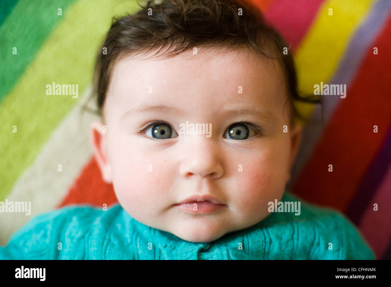 Beautiful Baby Girl with brown hair and blue eyes Stock Photo
