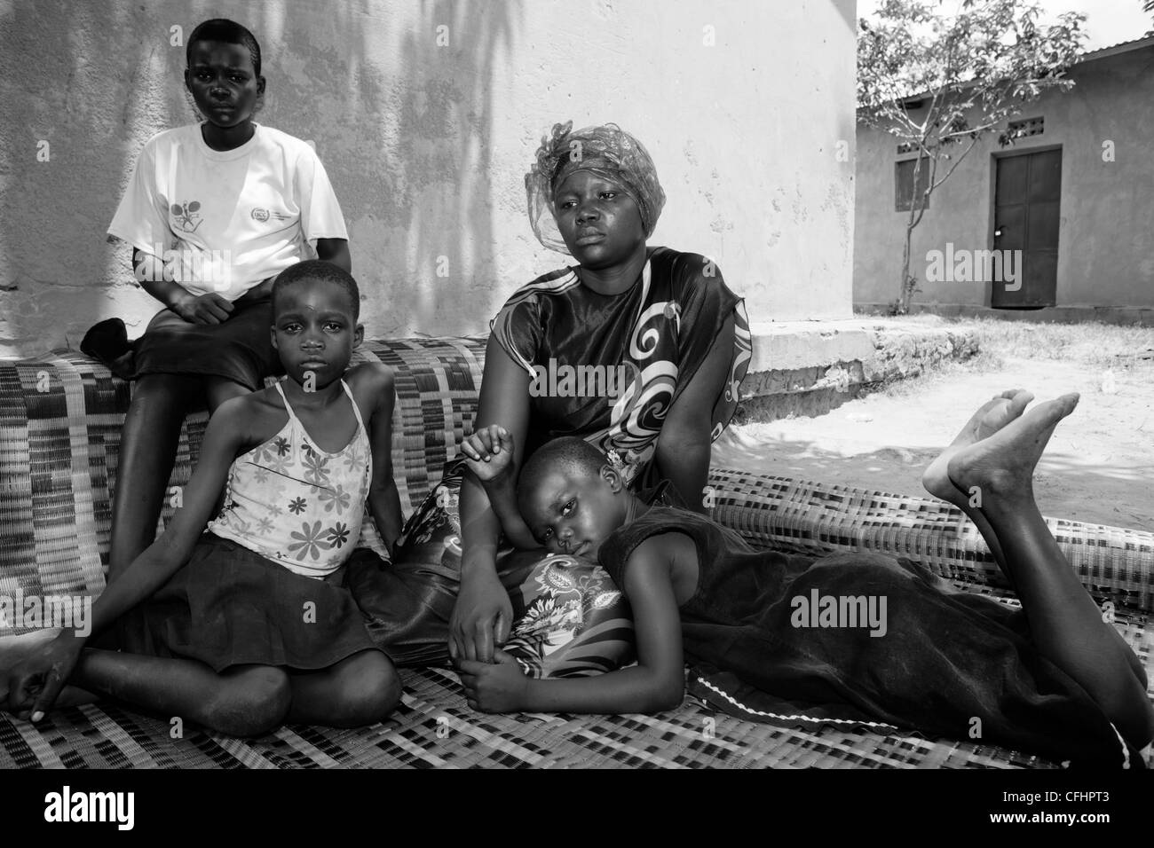 Portrait of one of Joseph Kony's wives and a former child soldier, Amony, with her three children by Kony Stock Photo