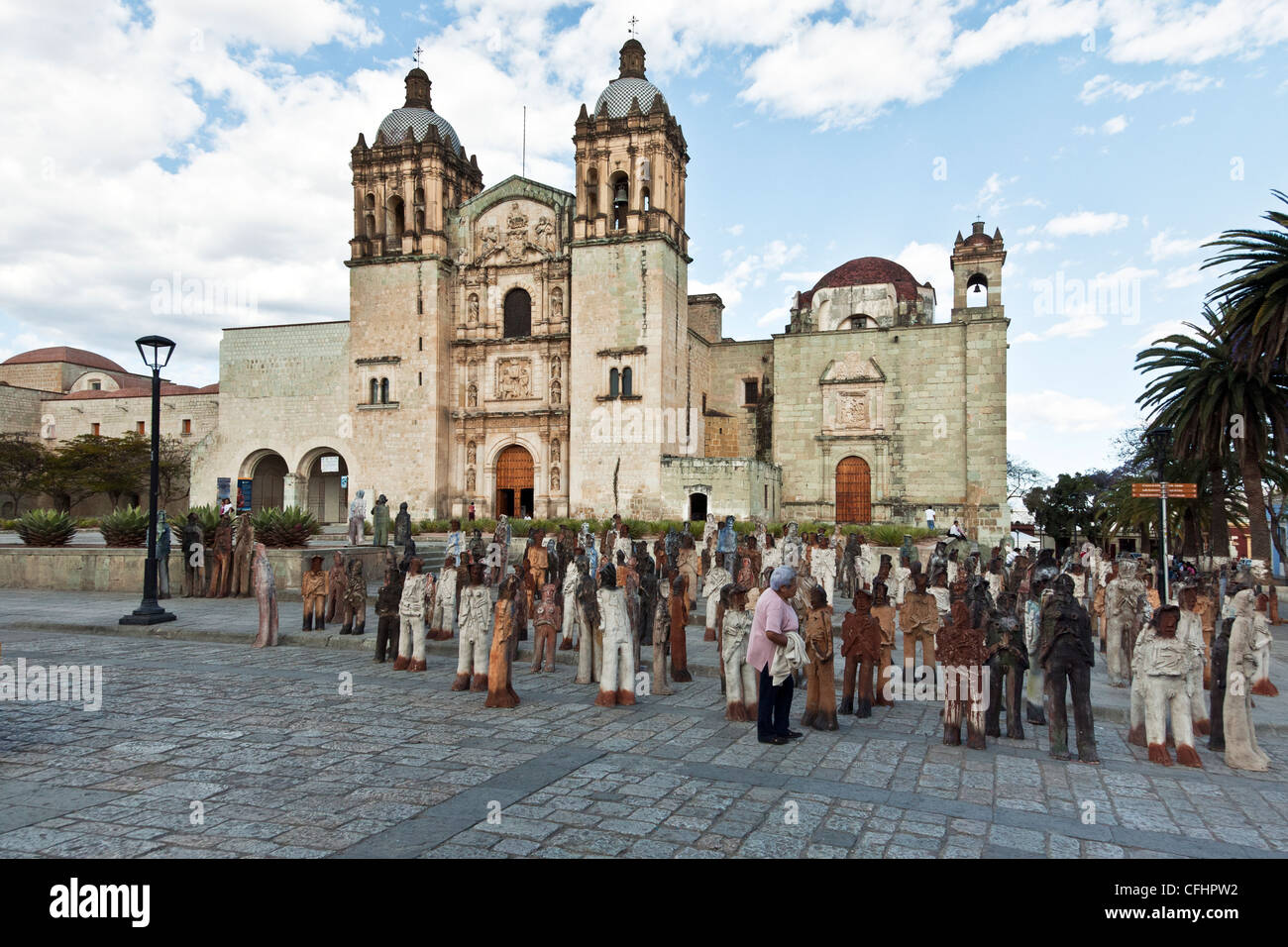real Mexicans mingle in a crowd of almost life size clay figures figurines in front of Santo Domingo Church Oaxaca Mexico Stock Photo