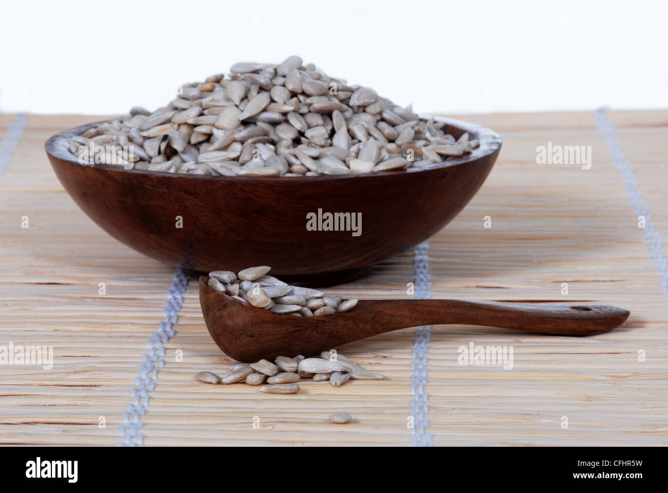 Sunflower seeds in a wood spoon, bowl. Stock Photo