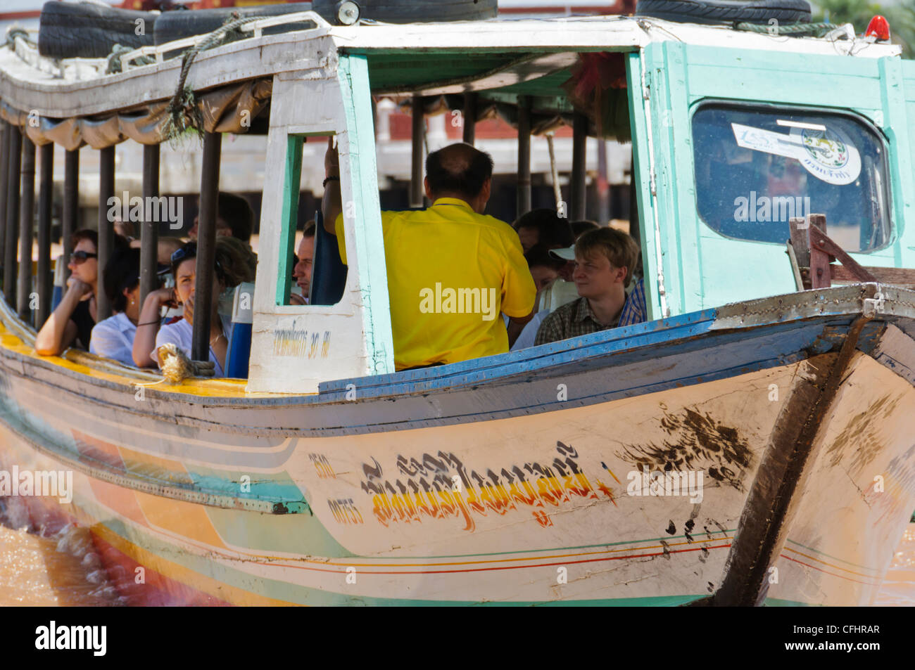 Tourist sightseeing boat with male tour guide on the Chao Phraya River, Bangkok, Thailand Stock Photo