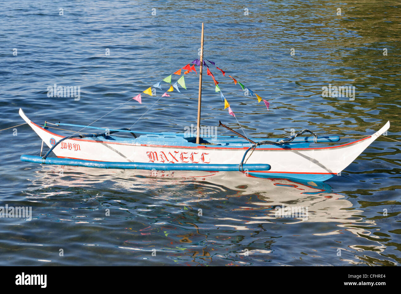 Small Traditional Philippine Outrigger Boat, Banca, Banka, with colorful  flags Stock Photo - Alamy