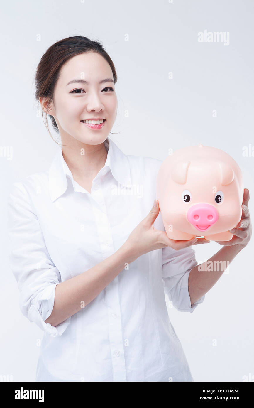 The smiling woman with piggy bank Stock Photo - Alamy