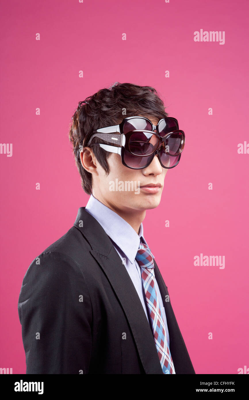 A man wearing many sunglasses on his eyes Stock Photo - Alamy
