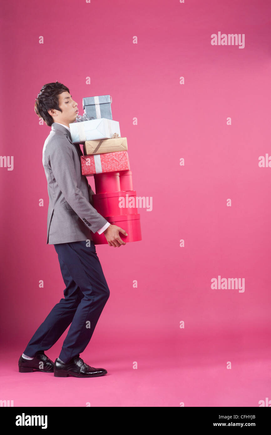 A man holding the many gift boxes Stock Photo