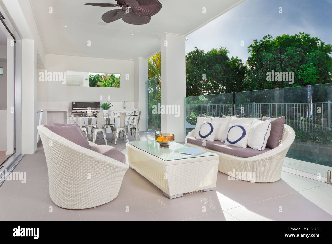 Luxurious undercover patio with couches, barbecue and dining area Stock