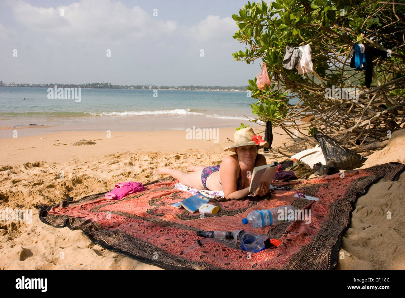 Tourist on sunny Jungle beach, Unawatuna Stock Photo