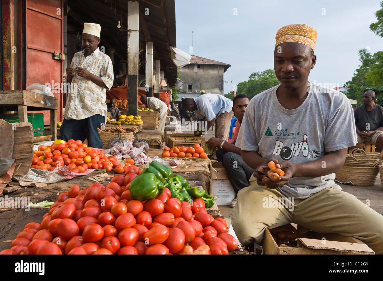 Man selling vegetables at his stall, Darajani Market in Stone Town Zanzibar Tanzania Stock Photo