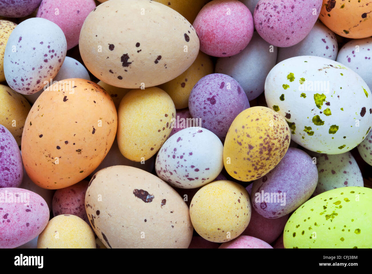 Still life photo of lots of colourful speckled candy covered chocolate easter eggs Stock Photo
