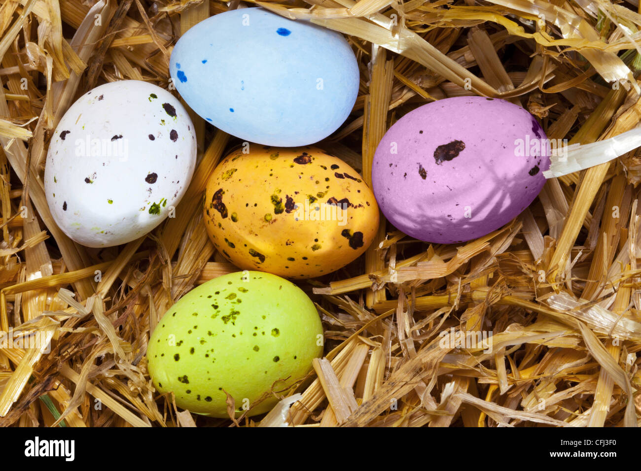 Photo of five speckled candy covered chocolate easter eggs in a straw