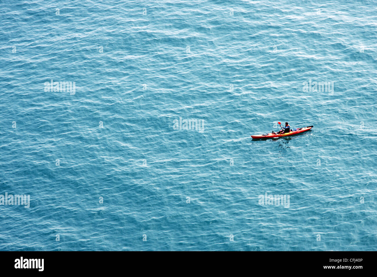 Canoe In Ocean One canoe and a canoeist in the ocean Stock Photo - Alamy