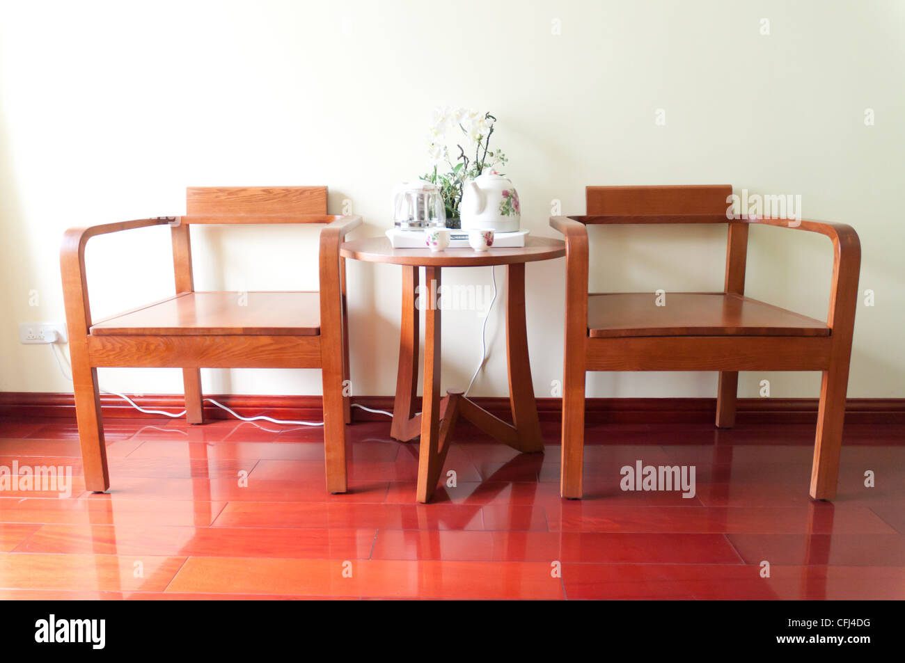 A pair of wooden chairs and tea table Stock Photo