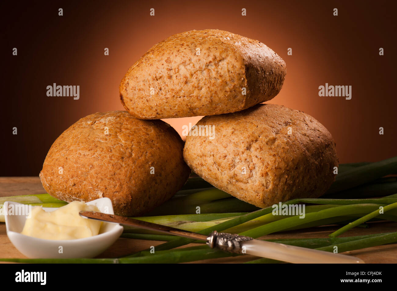 Wholemeal bread rolls on brown background Stock Photo - Alamy