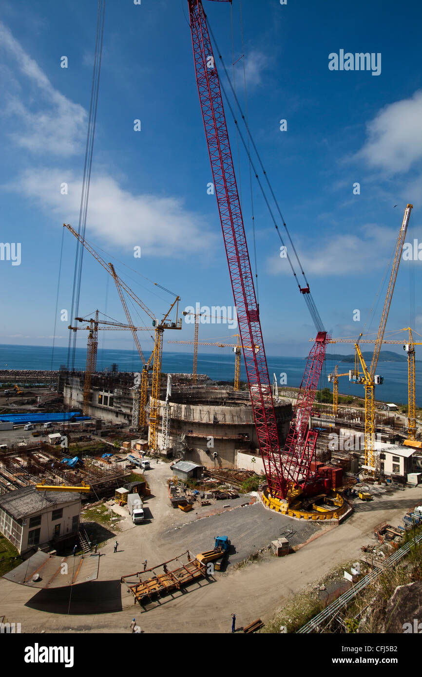 Cranes in operation at the construction of Angra 3 Nuclear Plant, Angra dos Reis, Brazil. Crane lifting a load Stock Photo