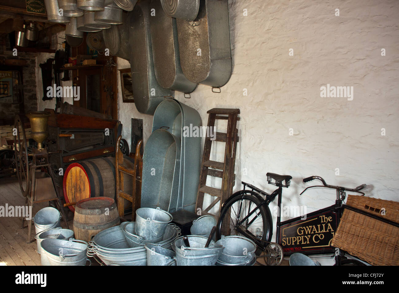 old grocery delivery bike in hardware shop with old fashioned tin ware