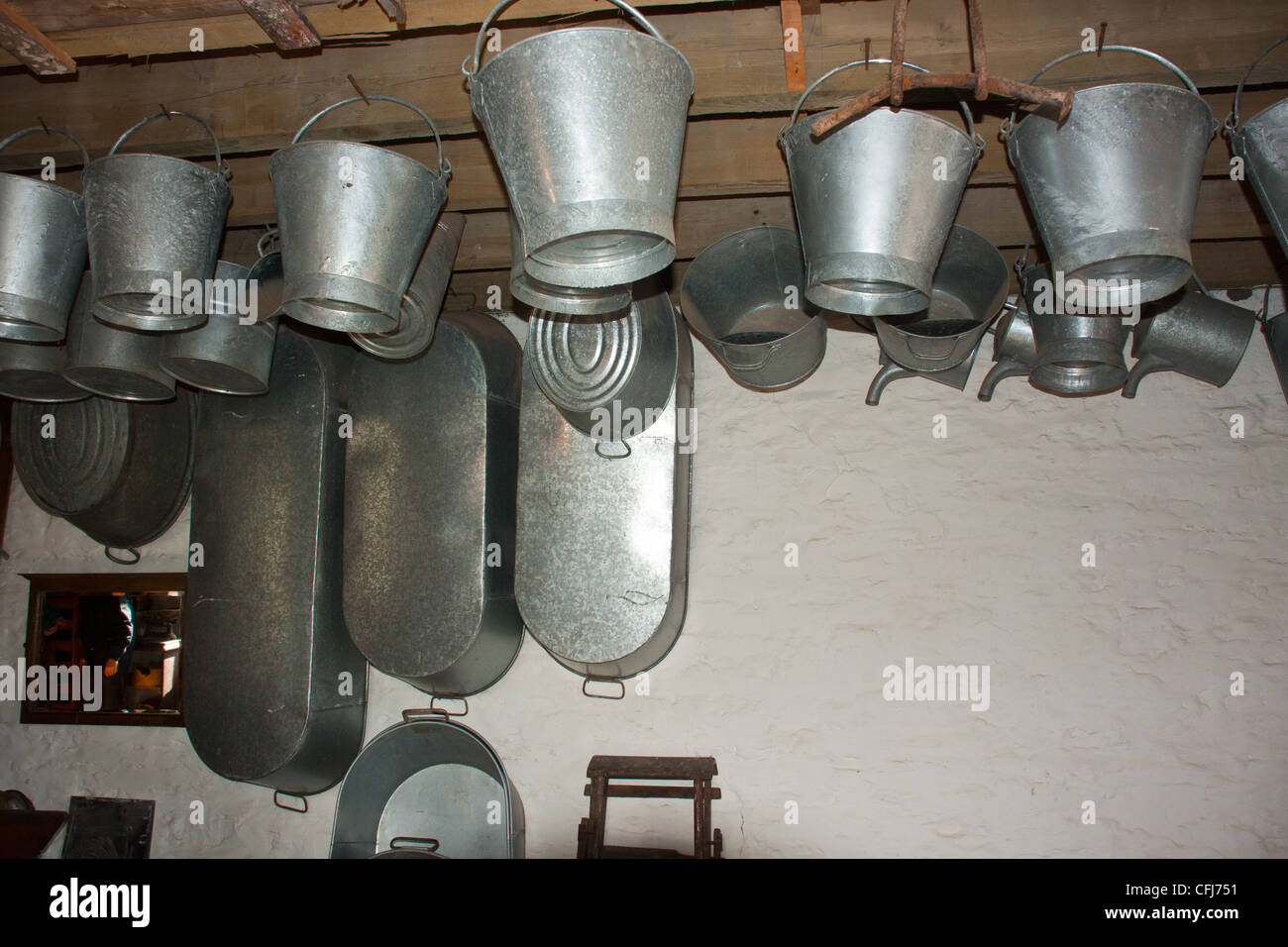 tin ware hanging from rafters in ironmonger's shop in old fashioned 1930's style shop store, Stock Photo