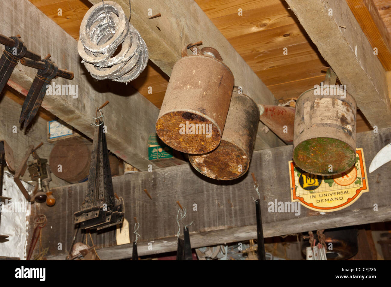 tin ware hanging from rafters in ironmonger's shop in old fashioned 1930's style shop store, Stock Photo