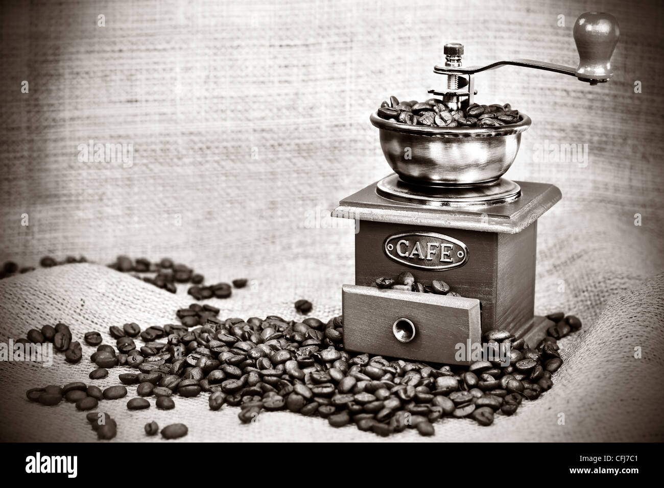 Contrast black&white image of vintage coffee mill or grinder with coffee beans .Dramatic