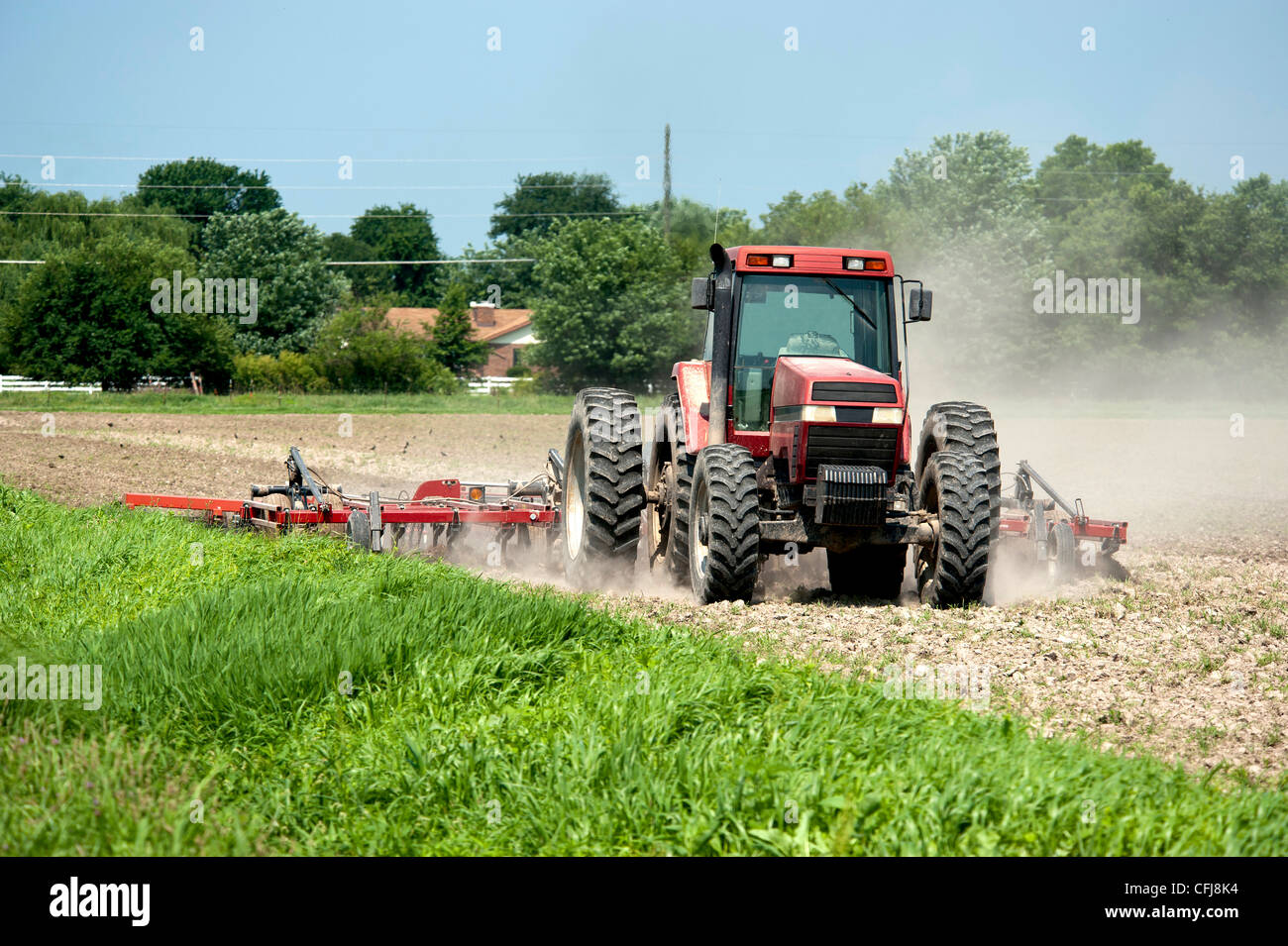 Farmer plows the fields Stock Photo