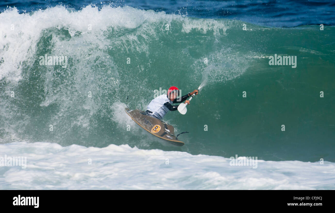2009 world surf kayak champion Adam Harvey surfing a large wave Stock