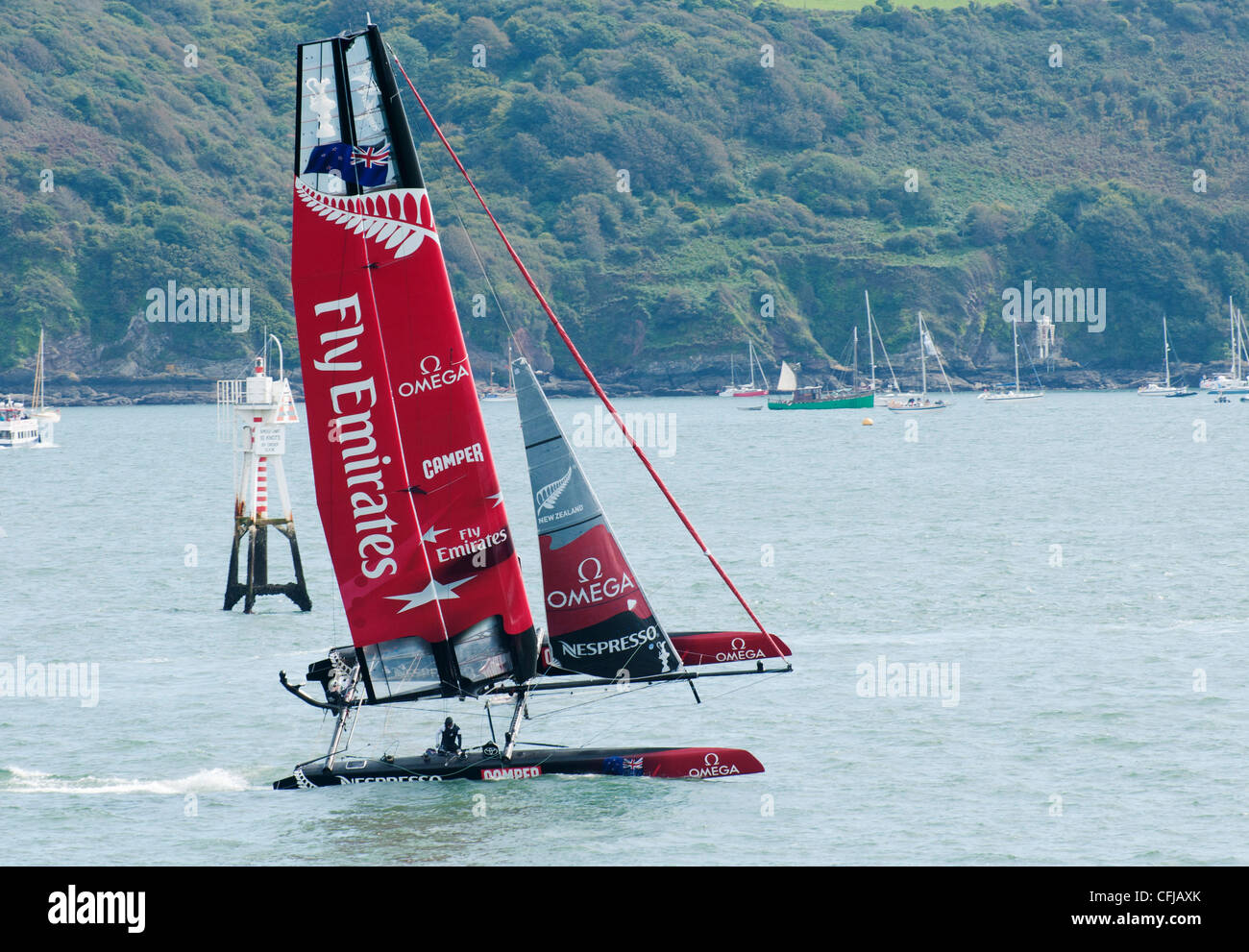 Fly Emirates New Zealand team catamaran flying across Plymouth Sound during America's Cup World Series, Plymouth, UK Stock Photo