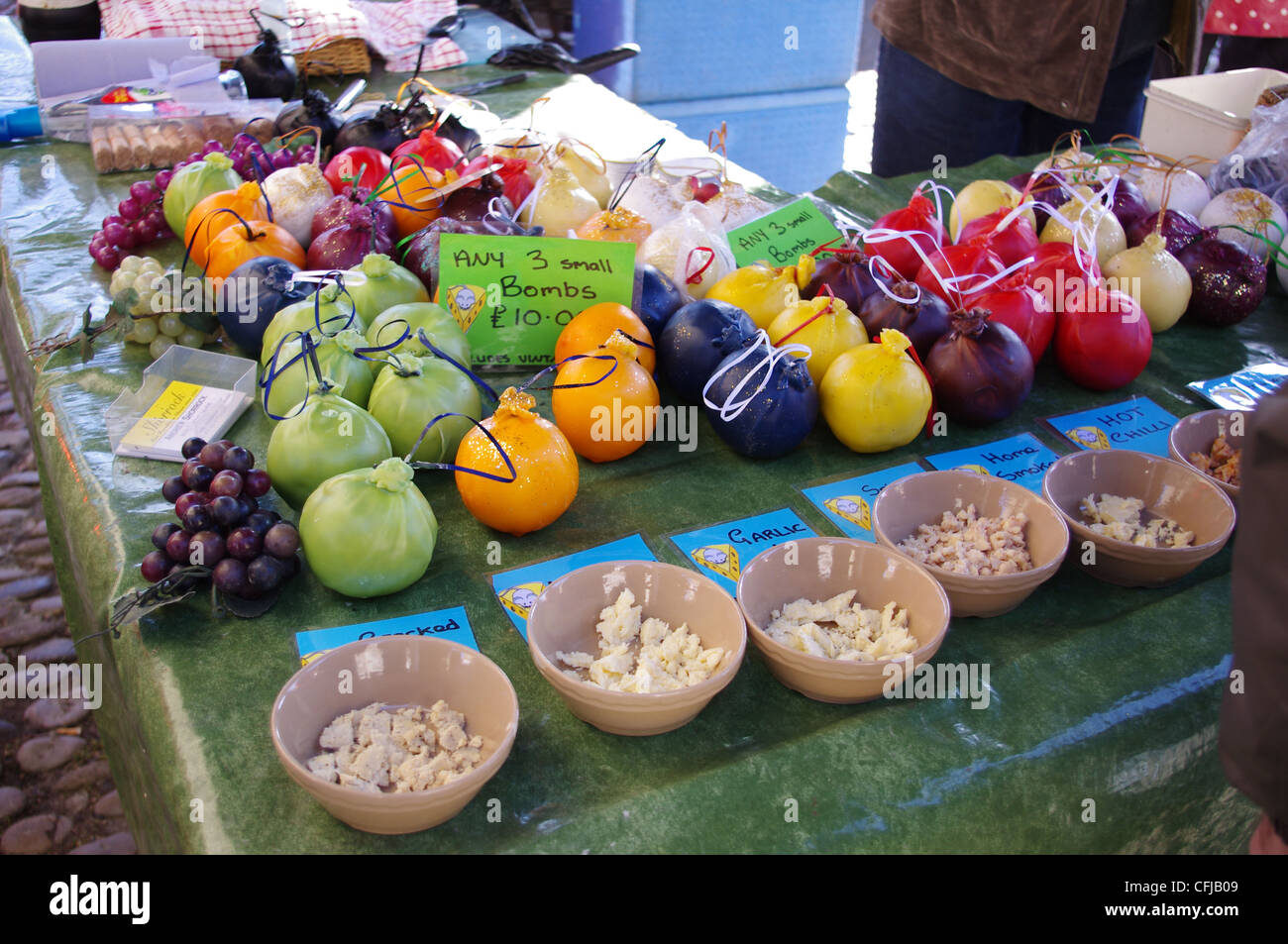 Waxed cheeses on a outdoor market stall Stock Photo