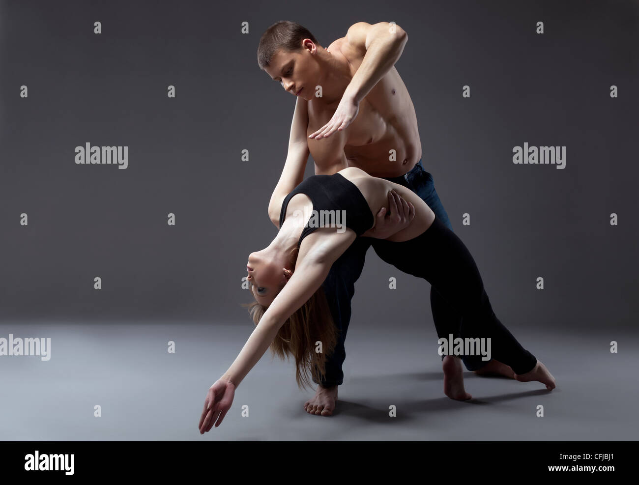 Couple of young gymnast posing in dance performance isolated Stock Photo