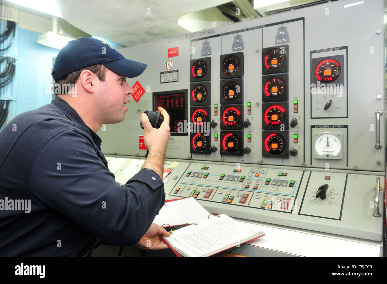 ATLANTIC OCEAN (March 13, 2012) Gas Turbine Technician (Electrician) 2nd Class Adam Beckedahl reports the electrical status aboard the guided-missile destroyer USS Laboon (DDG 58). Laboon is participating in a group sail with the Dwight D. Eisenhower Carrier Strike Group and six other ships in the Atlantic Ocean. Stock Photo