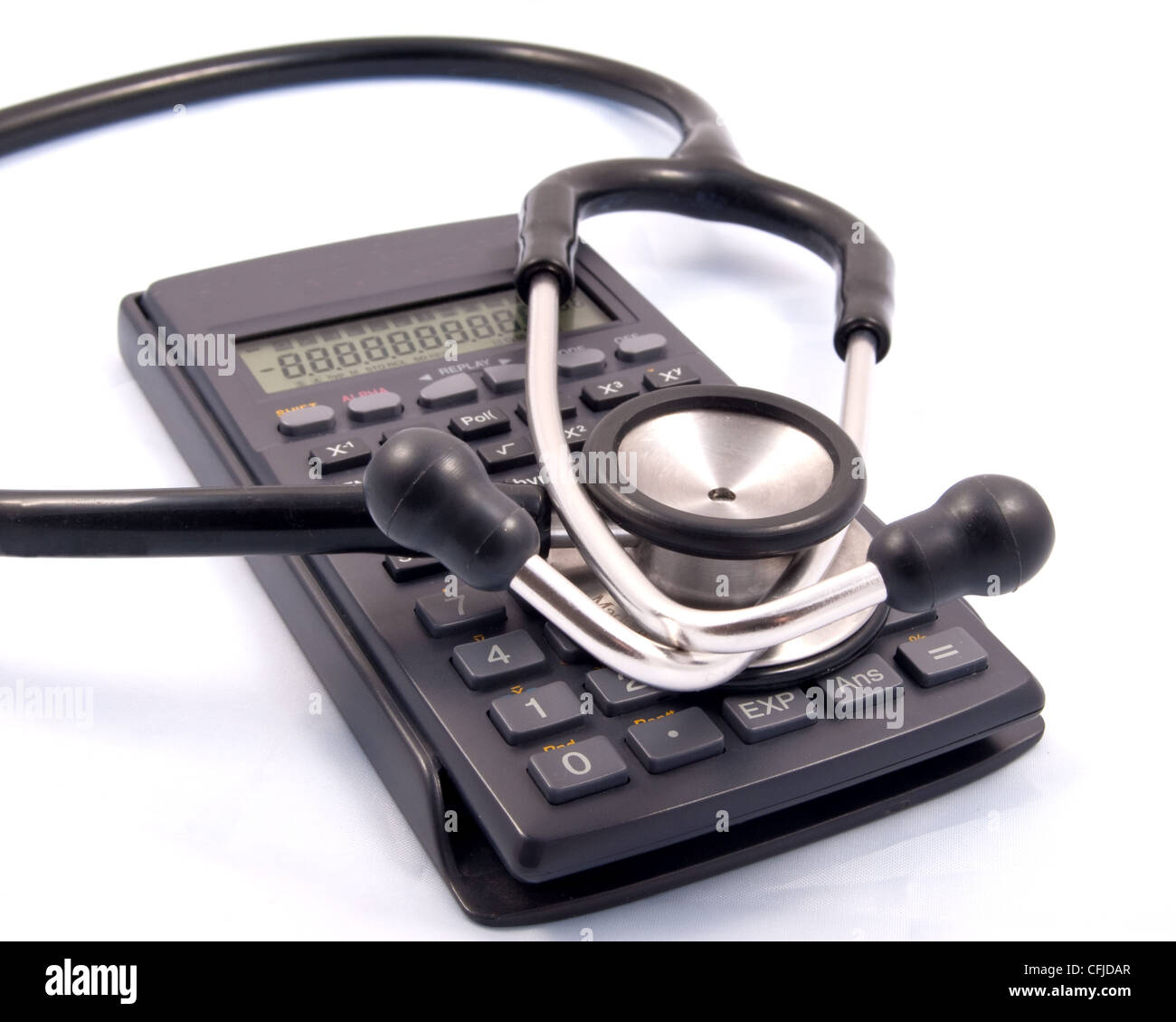 A calculator with a stethoscope placed over it for clinical finance Stock Photo
