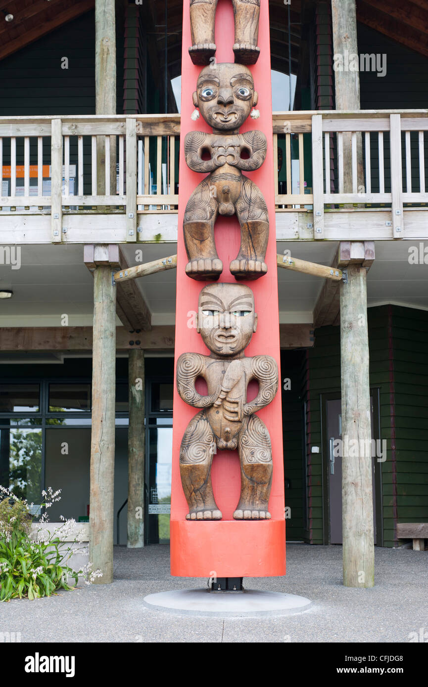 Maori carving on a pou (guardian post ) at Arataki Visitor Centre in the Waitakere Ranges Regional Park, Auckland. Stock Photo