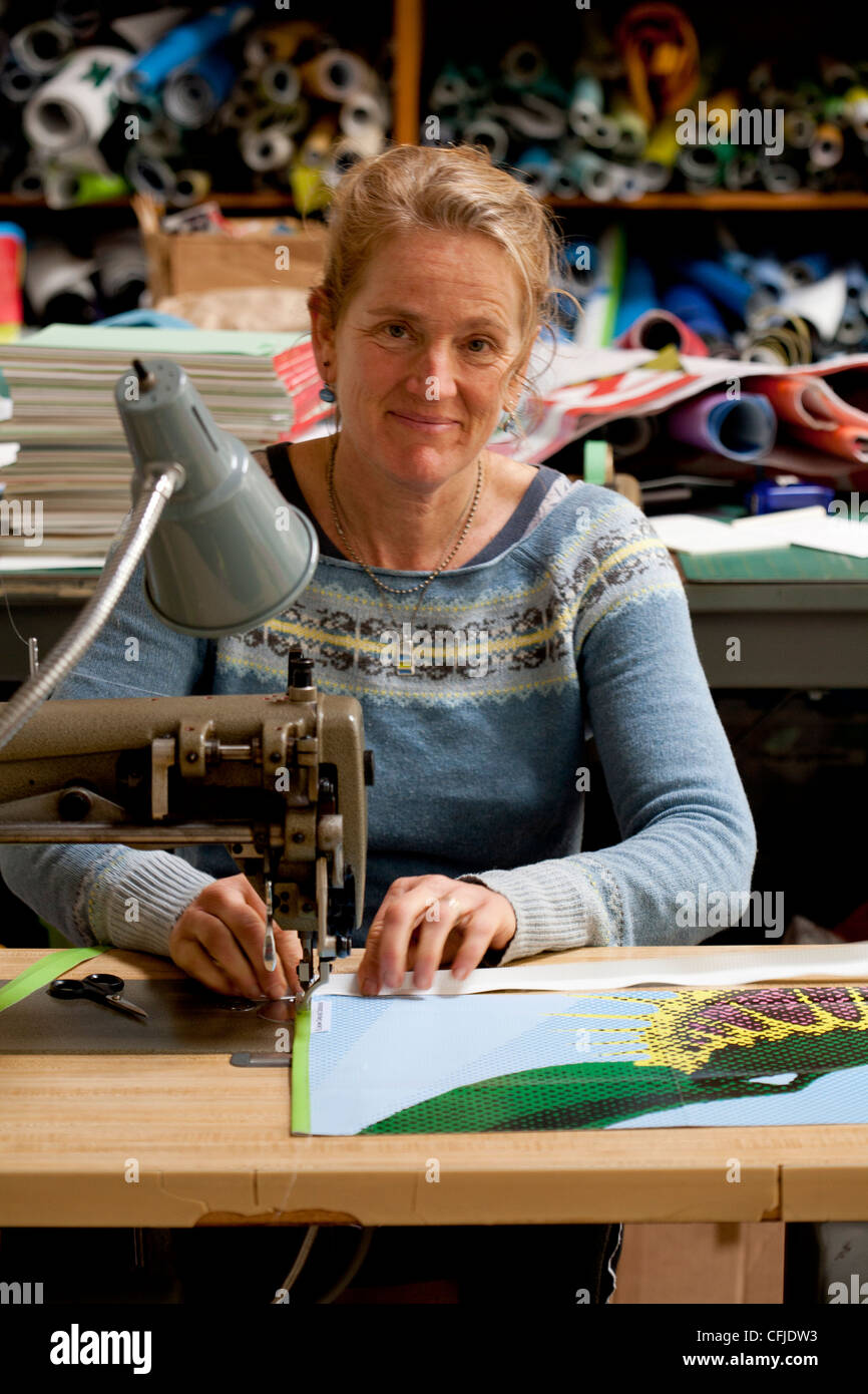 Seamstress recycling trade show banner vinyl into new products with