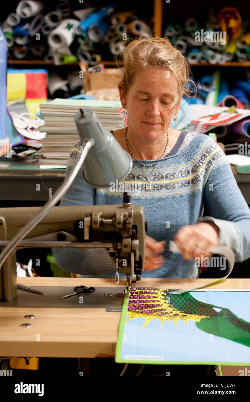Seamstress recycling trade show banner vinyl into new products with