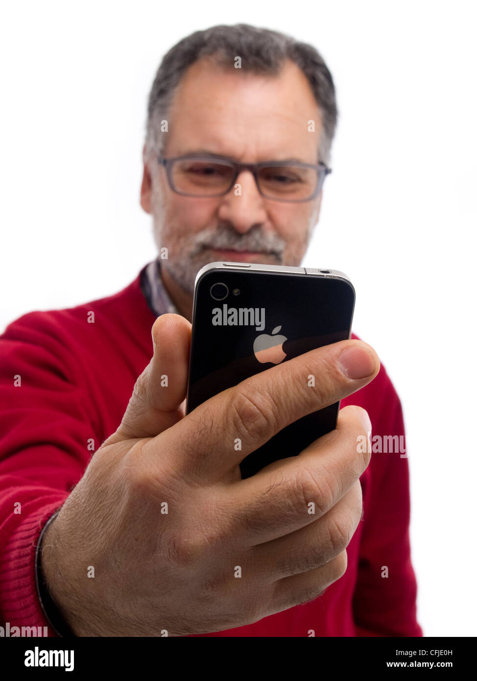 Middle-aged man holding iPhone isolated on white background Stock Photo