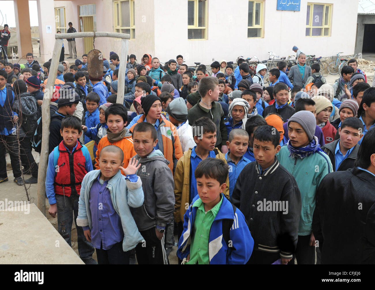 Young Afghan boys stand outside of the Aliabad School near Mazar-e-Sharif, Afghanistan, March 10, 2012. Their new school, a project started by the 1st Brigade, 10th Mountain Division, and continued by the 170th and 37th Infantry Brigade Combat Teams, is being built next to the current school and will accommodate the current volume of students with additional room for the town's growing population. Stock Photo