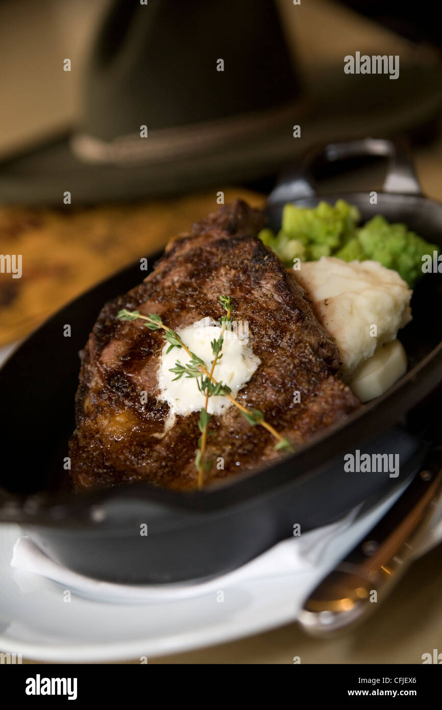 Sizzling TBone steak served in cast iron with mashed potatoes and broccoli Stock Photo Alamy