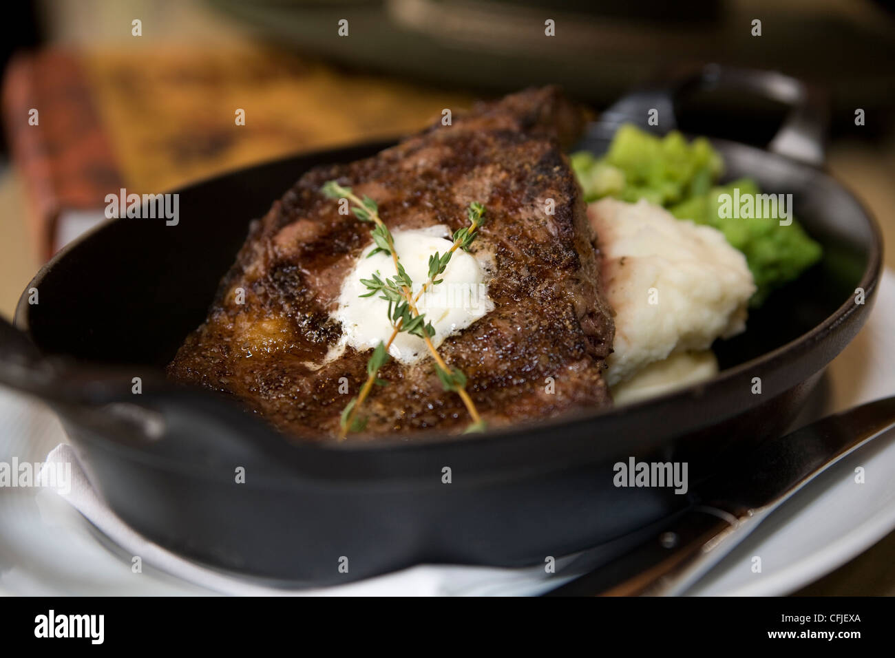Sizzling TBone steak served in cast iron with mashed potatoes and broccoli Stock Photo Alamy
