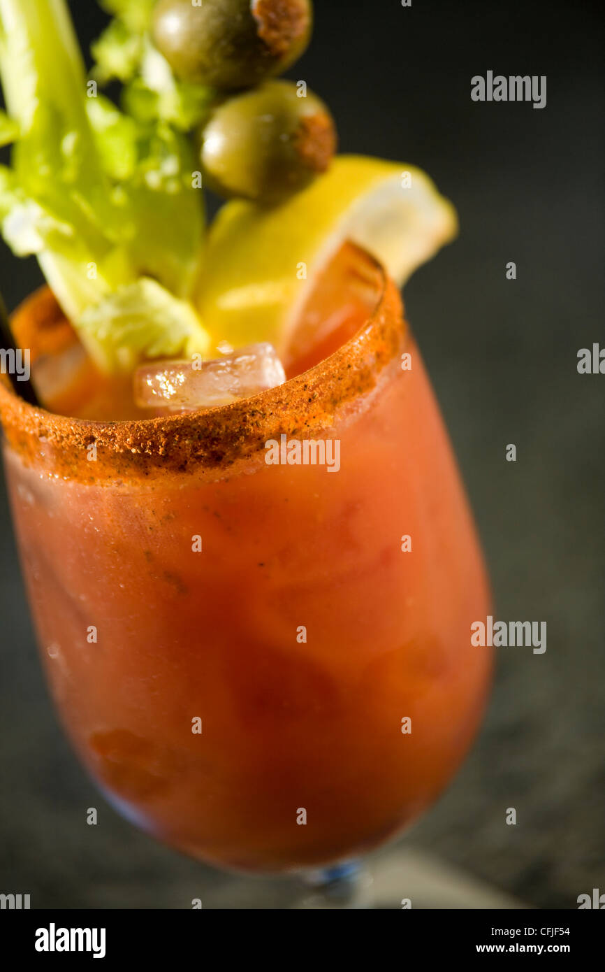 Classic Bloody Mary garnished with celery stick and stuffed olives Stock Photo