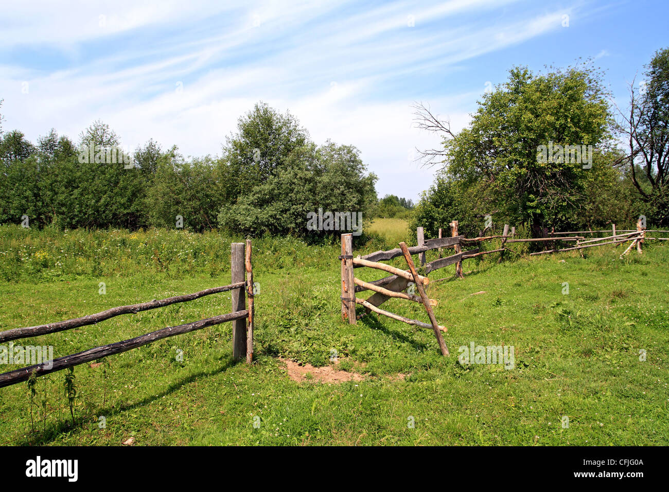 wooden fence on green pasture Stock Photo - Alamy