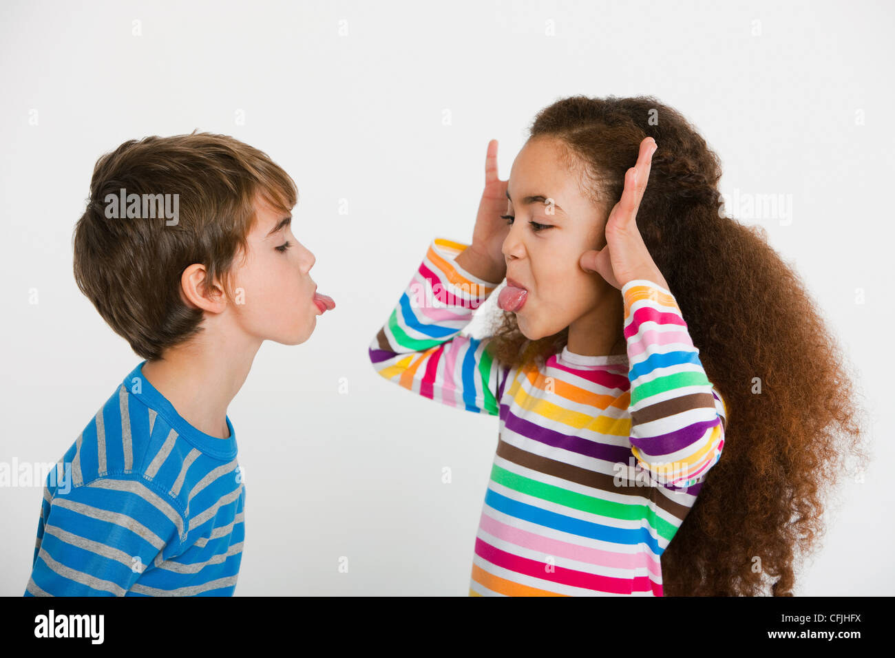 Children making faces at each other Stock Photo