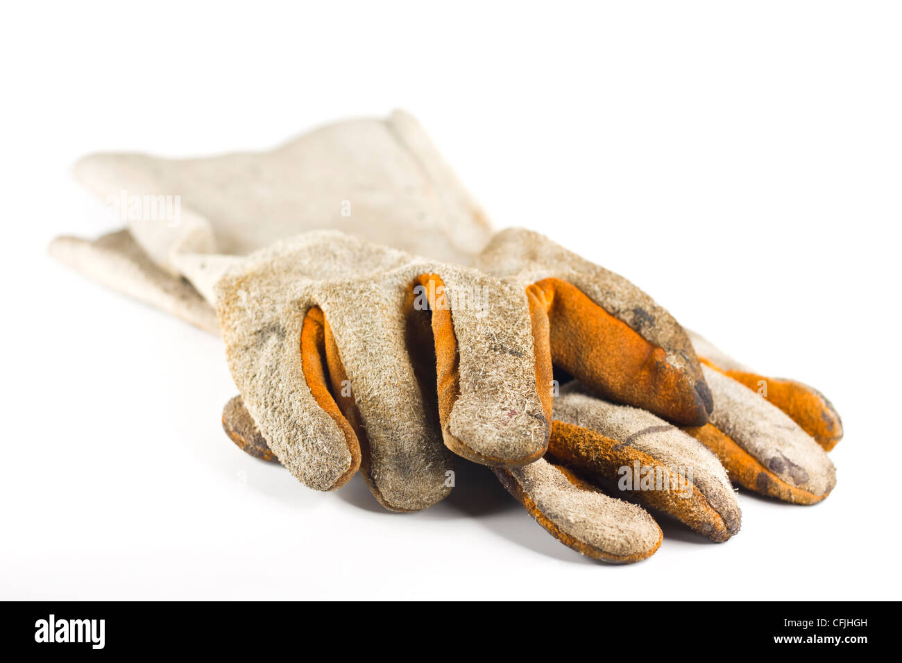 Dirty old leather gloves shallow focus isolated on white background
