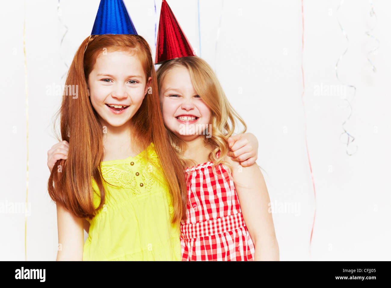 Happy girls in party hats Stock Photo - Alamy
