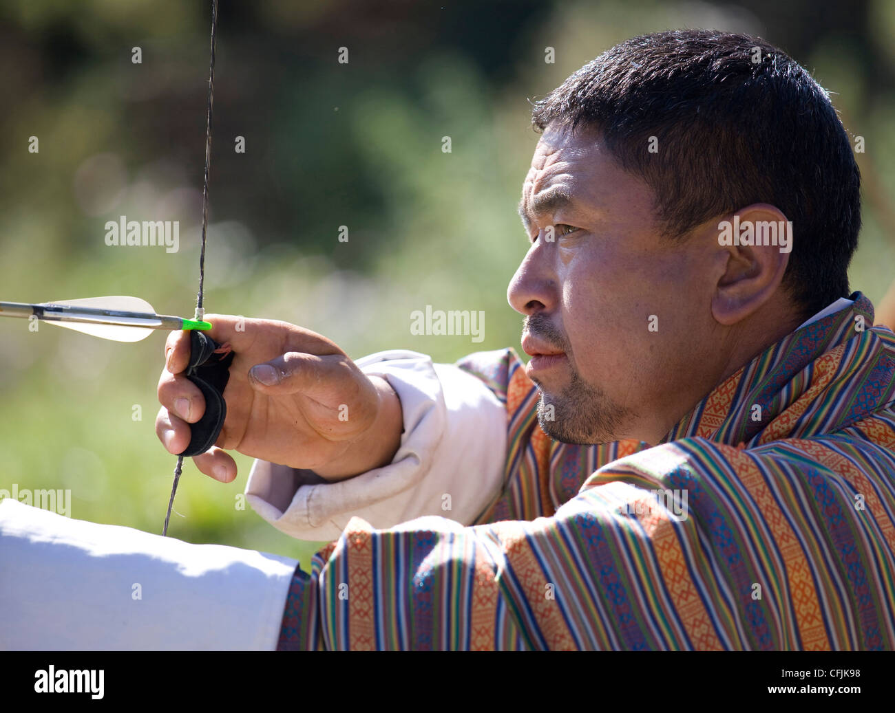 Local man taking part in archery competition using traditional bow