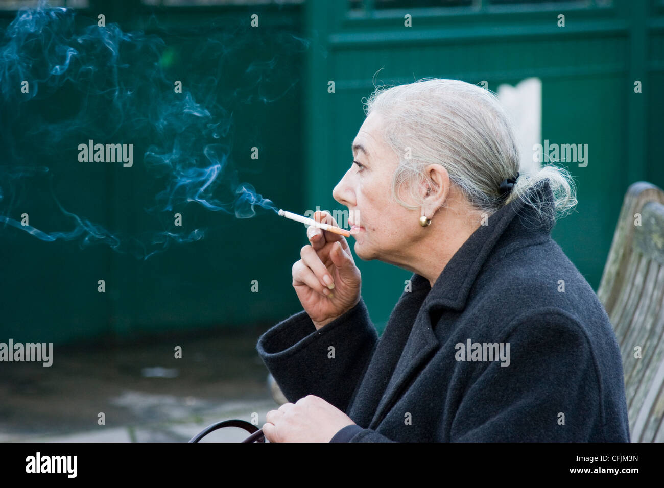 Lady smoking a cigarette - NO MODEL RELEASE AVAILABLE Stock Photo