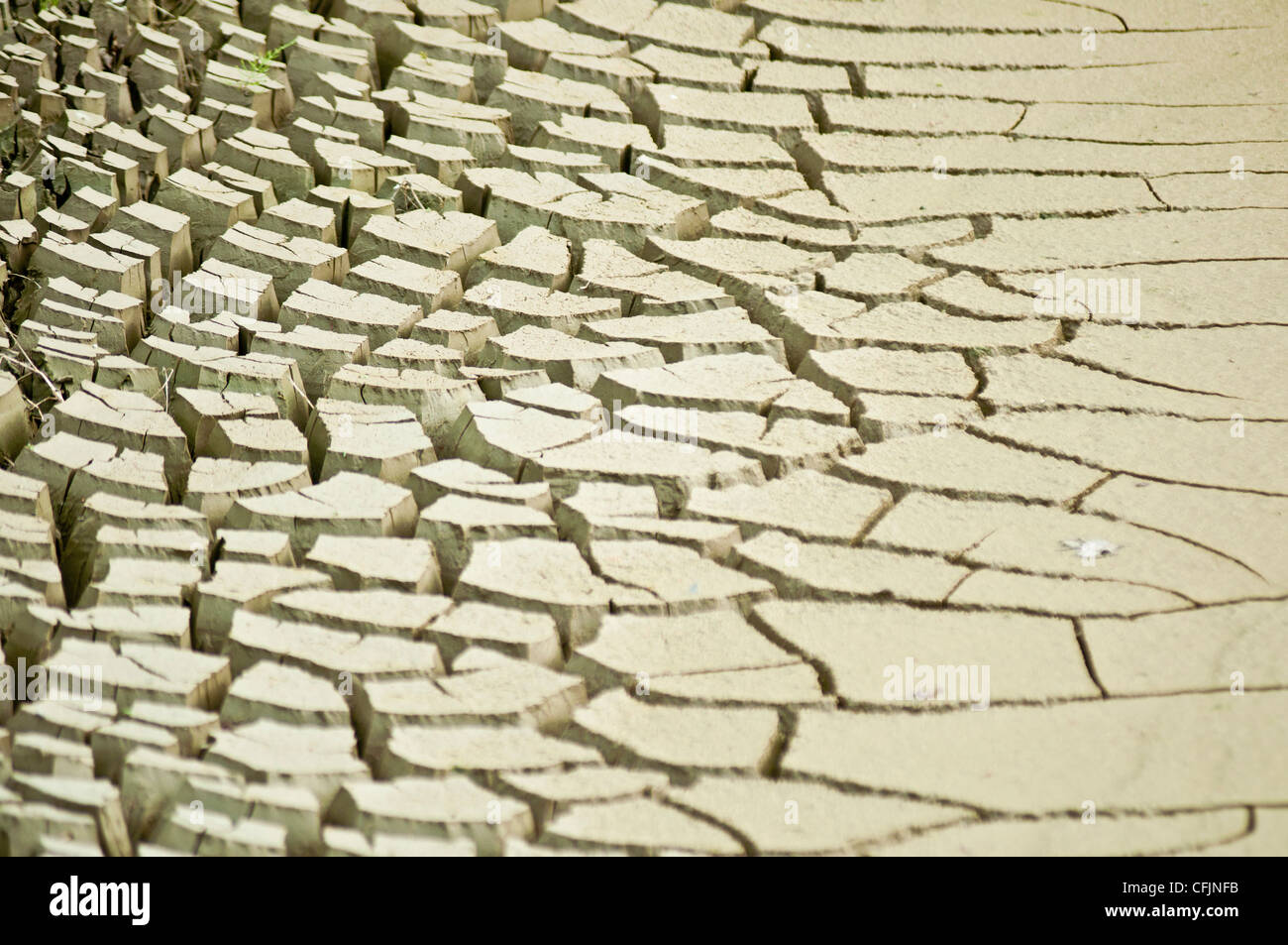 Dry heavy cracked Earth as a result of drought, parched mud, Stock Photo