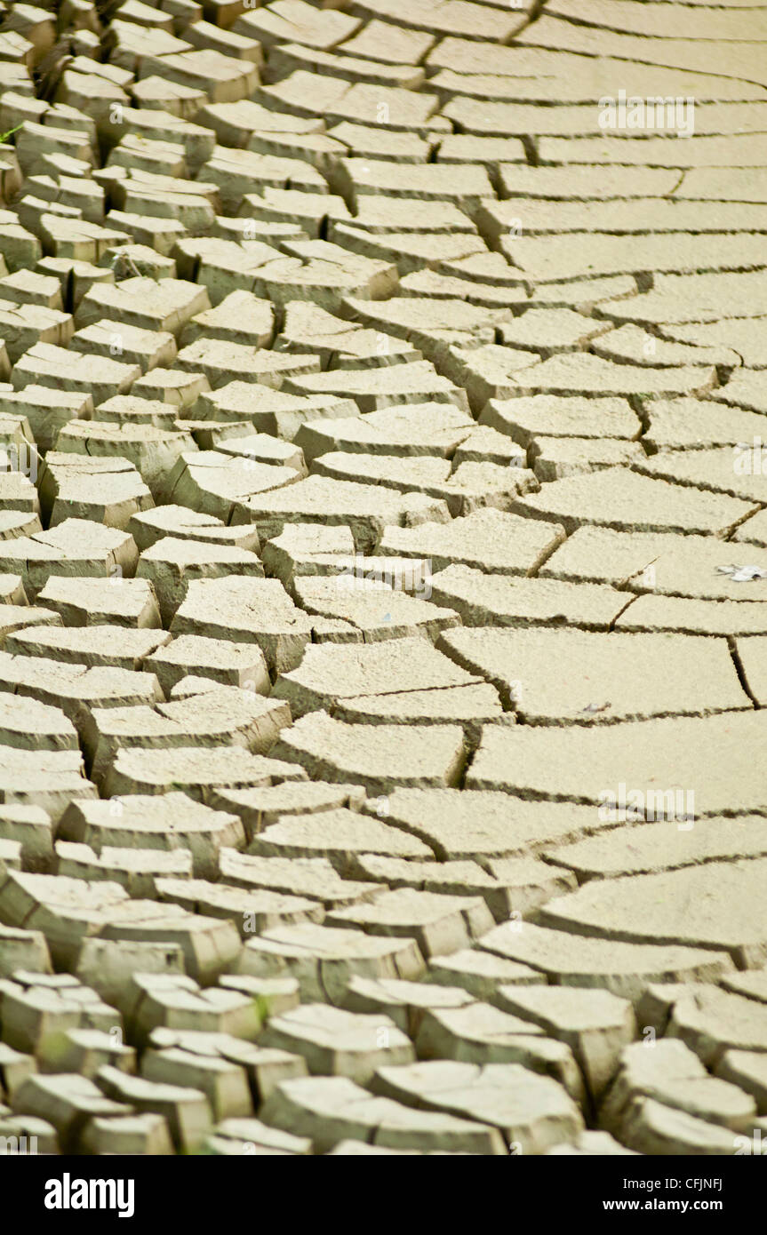 Dry heavy cracked Earth as a result of drought, parched mud, Stock Photo