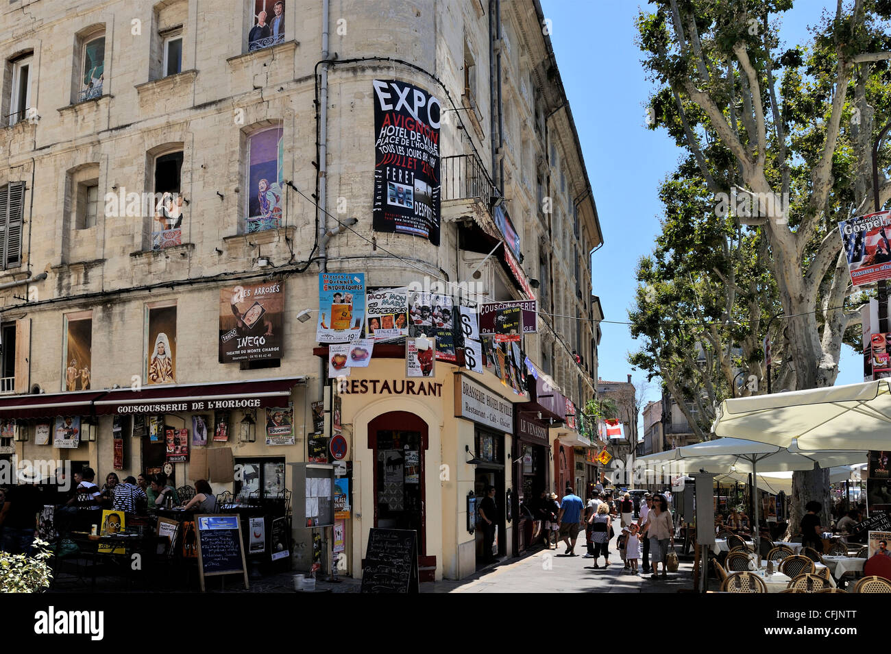 Posters advertising the theatre festival on a building with pictures painted on the windows, Avignon, Provence, France, Europe Stock Photo