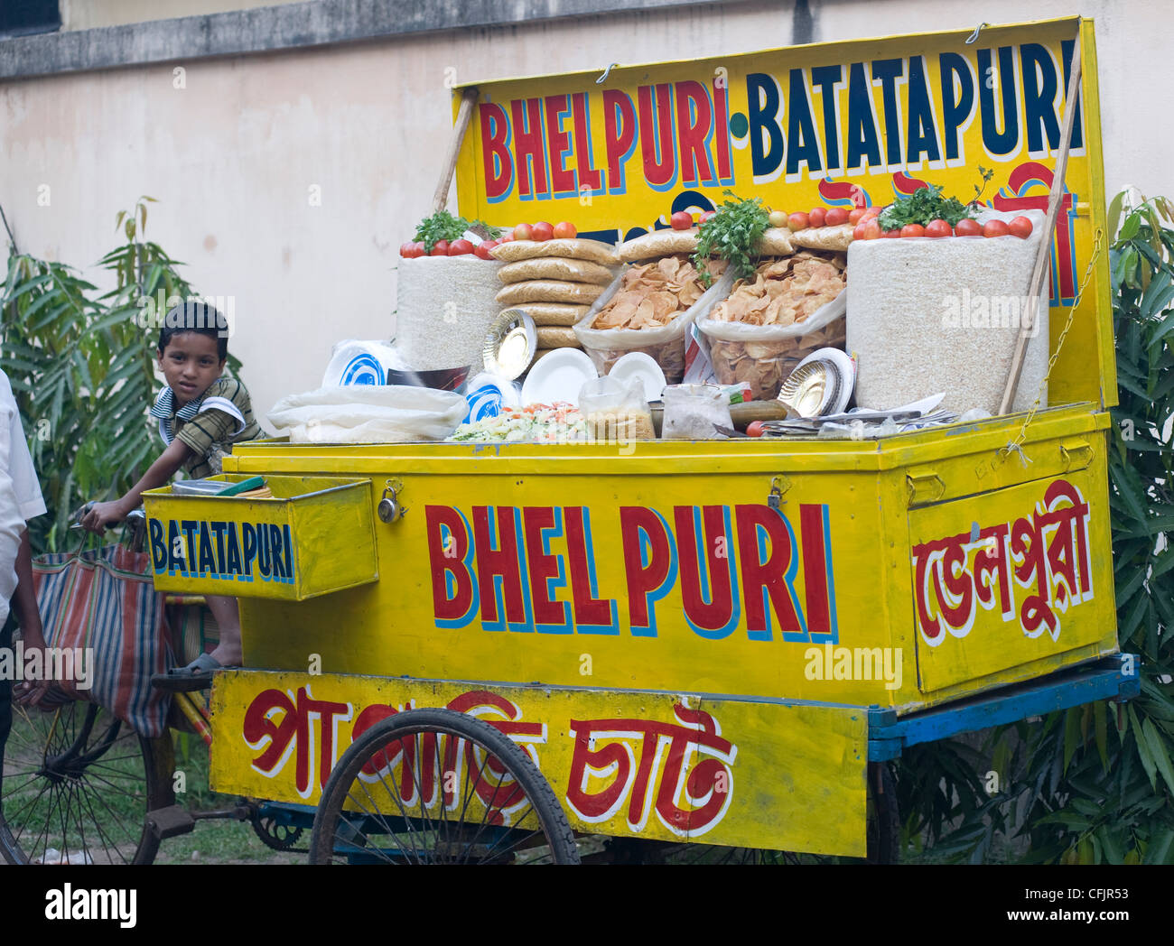 Boy watching bhel puri stall near Belur Math Swami temple, near Kolkata, West Bengal, India, Asia Stock Photo