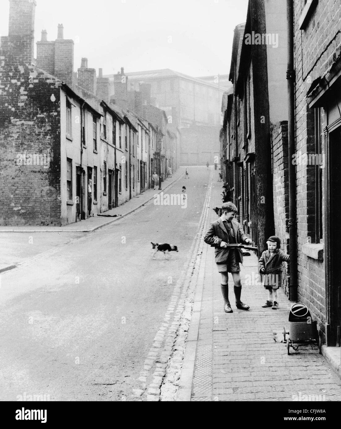 Terraced houses in Campbell Street Dudley West Midlands 1954 children playing in the street. Stock Photo